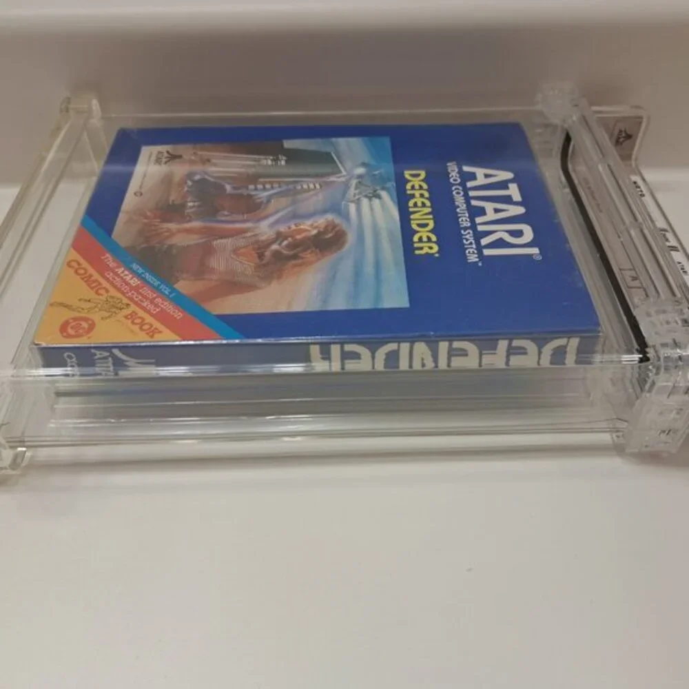 Atari 2600 DEFENDER - EARLY HANGTAB BLUE BOX! WATA GRADED 5.5! NEW & UNOPENED!